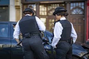 Two police officers talking to a member of the public