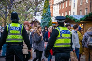 Two police officers walking through Christmas market